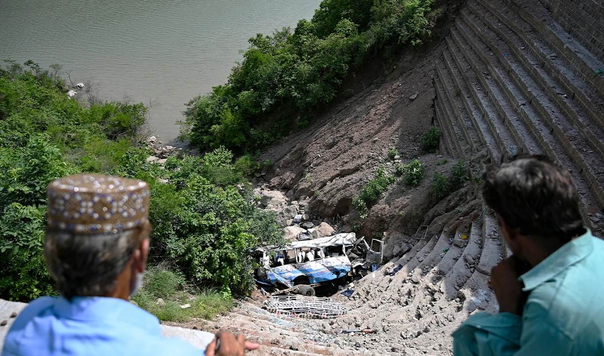 People look at the wreckage at the site of a bus accident that killed 23 people after it plunged into a ravine at Soon village near Kahuta, Punjab province on August 25, 2024. (AFP/ file)