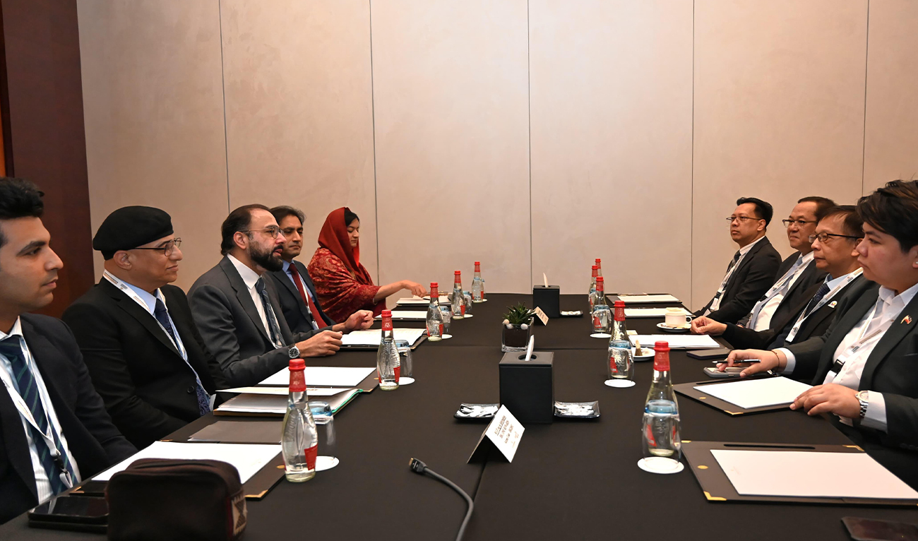 The photo taken on February 1, 2026, shows Pakistan's Minister for Overseas Pakistanis and Human Resource Development Chaudhry Salik Hussain and Dr. Asif Nazrul, adviser to the Ministry of Expatriates’ Welfare and Overseas Employment of Bangladesh along with their respective delegations on the sidelines of the Abu Dhabi Dialogue 2026. (Ministry of Overseas Pakistanis)