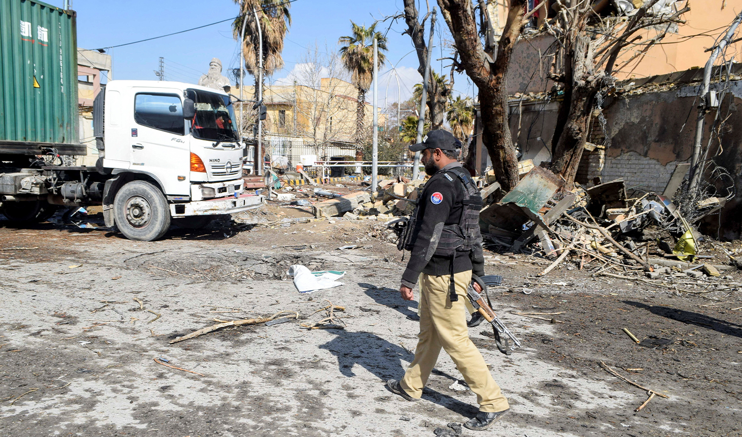 A police officer walks past damage at the site, after militant attacks, in Quetta, Pakistan, on February 1, 2026. (REUTERS)