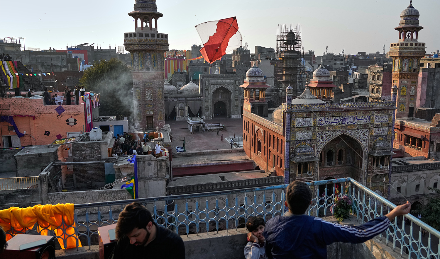 A man flies a kite from the rooftop of his house to celebrate three-day kite flying festival 'Basant', in Lahore, Pakistan, on Feb. 6, 2026. (AP)