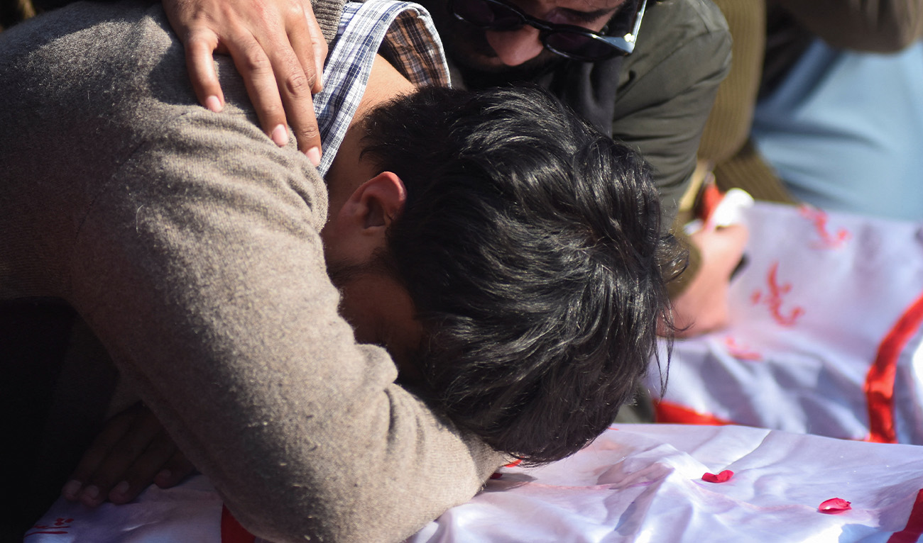 A man mourns over a coffin of his relative, during a funeral for victims following the suicide explosion at a Shi'ite Muslim mosque, in Islamabad, Pakistan, February 7, 2026. (Reuters)