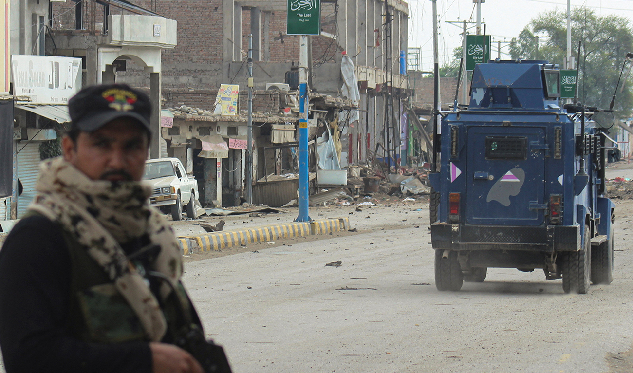 A police officer stands guard on a street with damaged shops in the background, following a militant attack on the Frontier Constabulary (FC) headquarters in Bannu, Khyber Pakhtunkhwa province, in Pakistan September 2, 2025. (REUTERS)