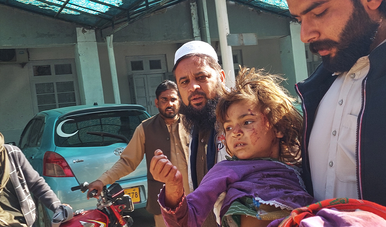 A man rushes with a baby girl, who was injured in a bomb explosion, for her treatment at a hospital in Bannu, northwestern Pakistan, on February 16, 2026. (AP)