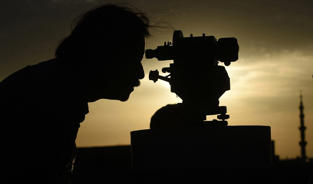 A member of Pakistan's Ramadan moon-sighting committee uses a telescope to observe the appearance of the Ramadan Moon in Karachi on March 22, 2023, to mark the beginning of the holy month of Ramadan. (AFP/File)