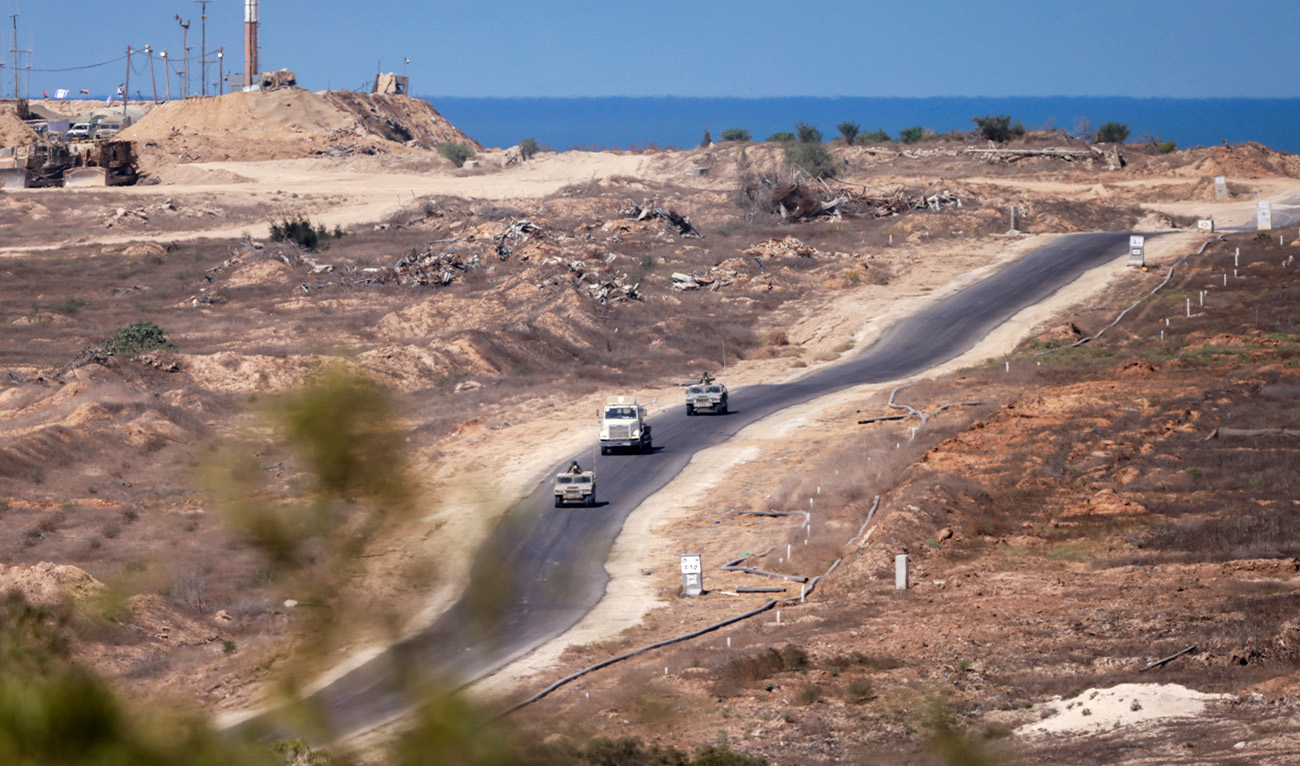 This picture taken from a position in southern Israel, near the border with the Gaza Strip, shows an Israeli military convoy returning from Gaza on October 11, 2025.