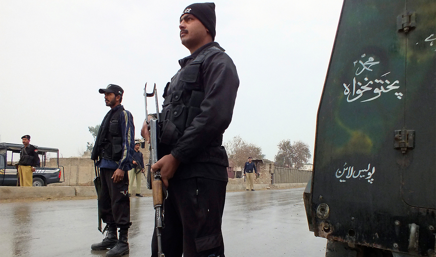 Policemen stand guard as they cordon the road leading to an isolated army checkpoint after it was attacked by militants at Lakki Marwat in the outskirts of Dera Ismail Khan on February 2, 2013. (REUTERS/File)
