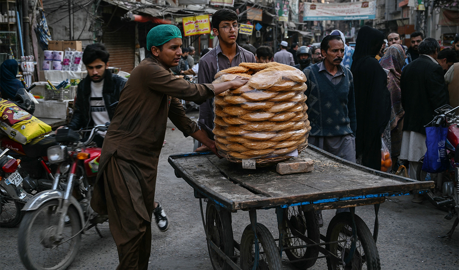 People transport vermicelli loaded on a cart on the first day of the Islamic holy fasting month of Ramadan in Rawalpindi on February 19, 2026. (AFP)