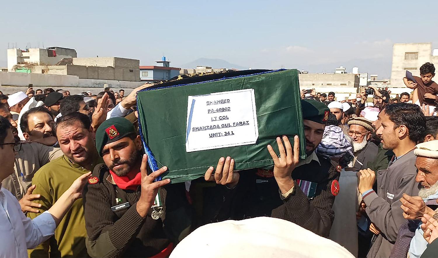 Relatives and army personnel carry the coffin of a Pakistani army officer who was killed in a recent suicide attack during his funeral in Mansehra on February 22, 2026. (AFP)