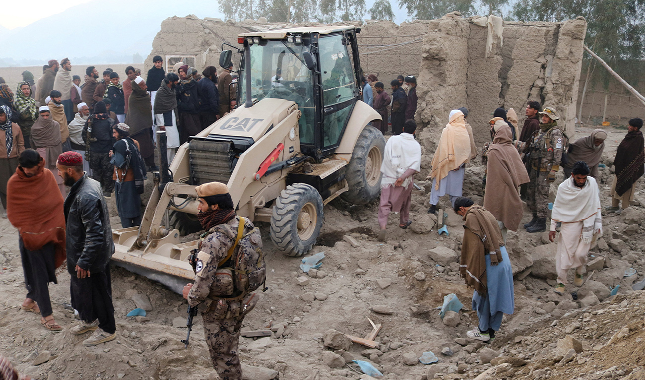 Residents gather near a damaged house as a loader clears debris, following the Pakistani airstrikes, in Bihsud district, Nangarhar province, Afghanistan, February 22, 2026. (REUTERS)