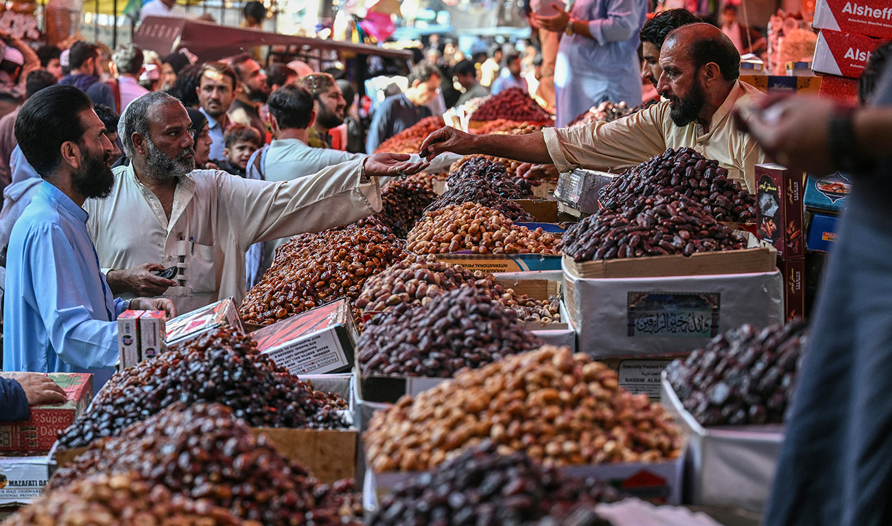 People buy dates at a market in Karachi on February 16, 2026, ahead of the Islamic holy fasting month of Ramadan. (AFP/ file)