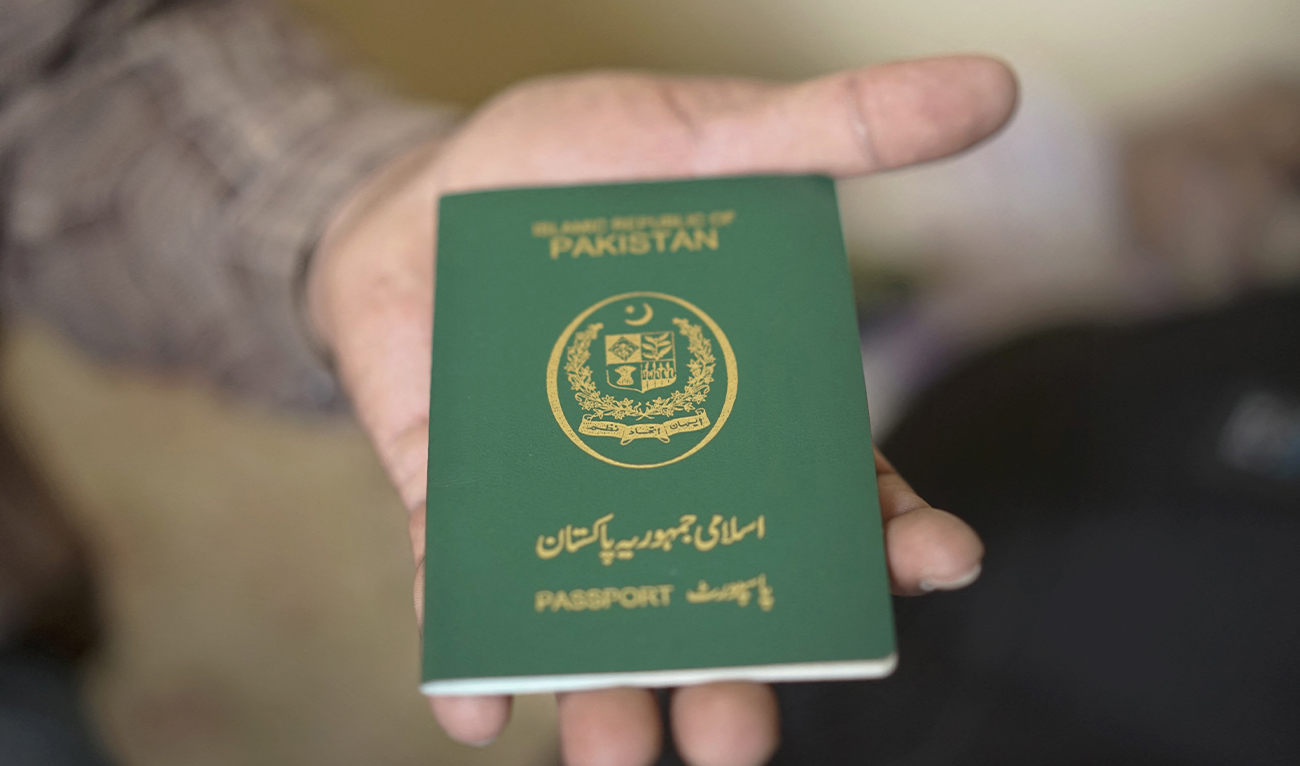 This photo taken on November 3, 2018, shows a man holdong a Pakistani passport in Bangkok, Thailand. (AFP/File)