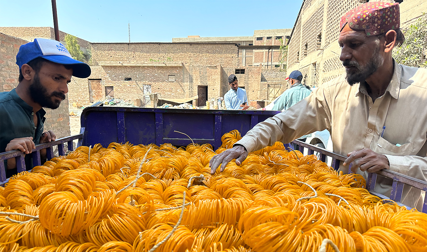 Workers load bangles into the back of a vehicle at a factory for transport to a vendor in Hyderabad, Pakistan, on February 21, 2026. (AN photo)