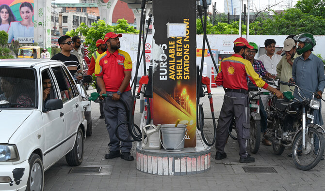 A worker pumps petrol in vehicles at a fuel station in Rawalpindi on July 16, 2023. (AFP/File)