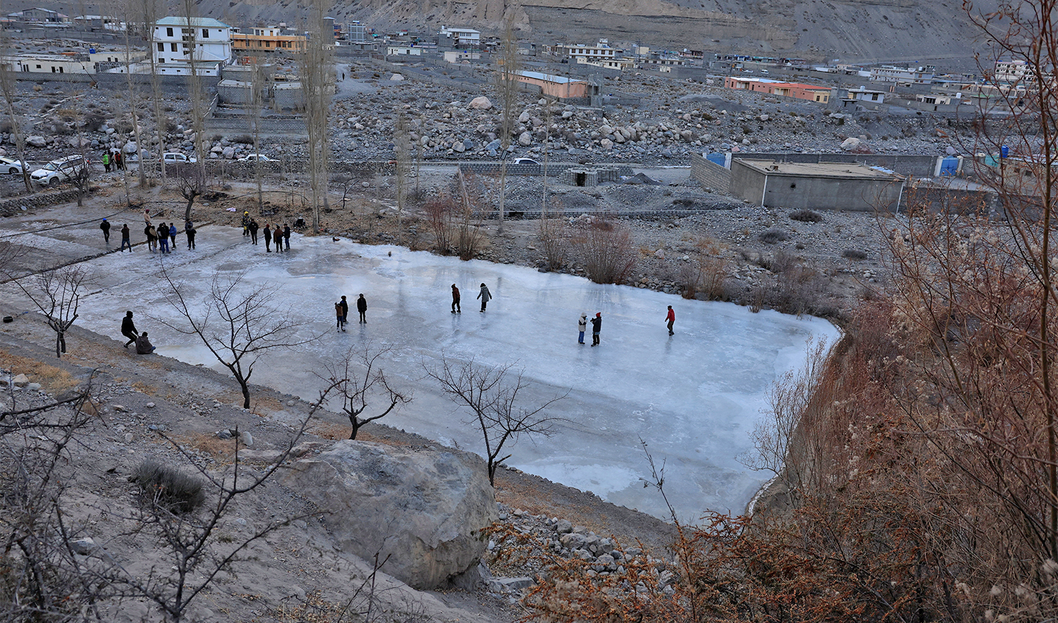 Residents and players inspect an unfinished man‑made ice rink, built after natural lakes froze later than usual, following the Karakoram WinterLude Season 8 ice hockey match, in Sost village in the Gojal area of Upper Hunza Valley, Gilgit Baltistan, Pakistan, January 11, 2026. (REUTERS)