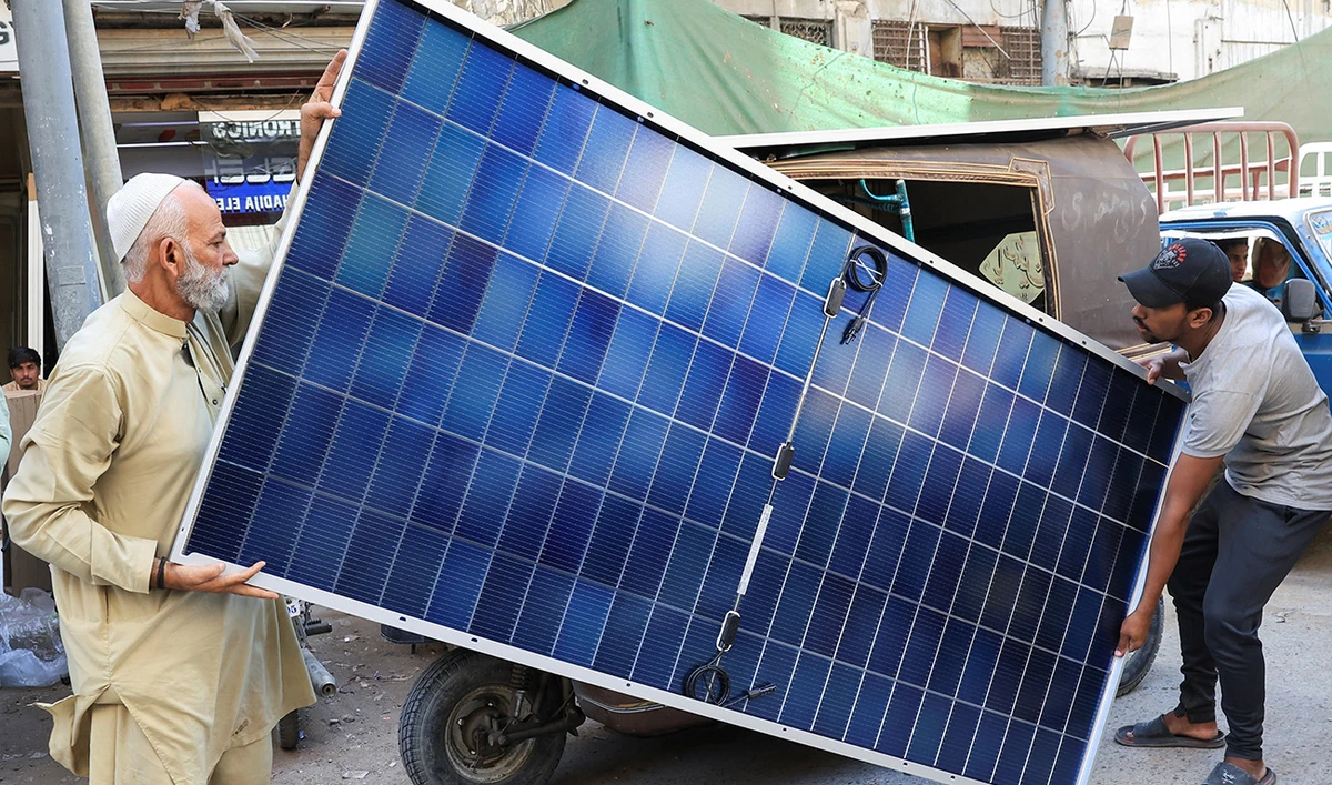 Men load solar panels on a rickshaw (tuk tuk) at a market, in Karachi, Pakistan March 26, 2025. (Reuters/File)