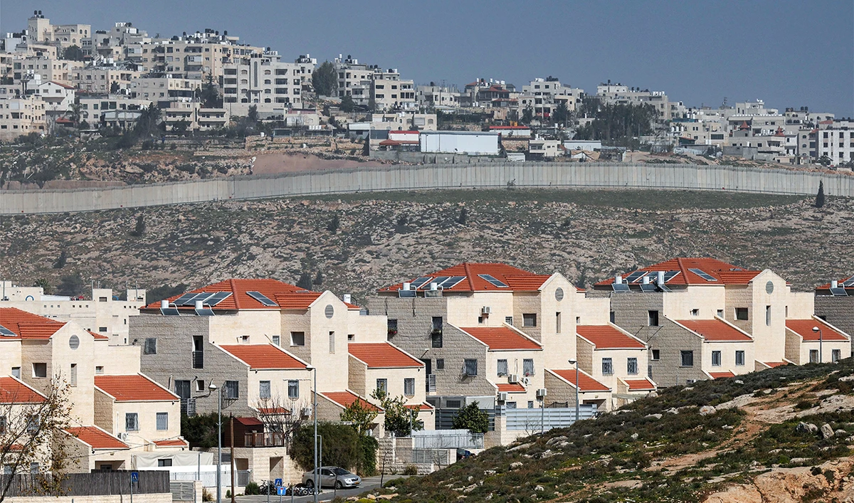 The Israeli settlement of Neve Yaakov (foreground) in the northern area of east Jerusalem and Israel's controversial barrier separating the Palestinian neighbourhood of al-Ram (background) are pictured in the occupied West Bank on February 16, 2026. (AFP/ file)