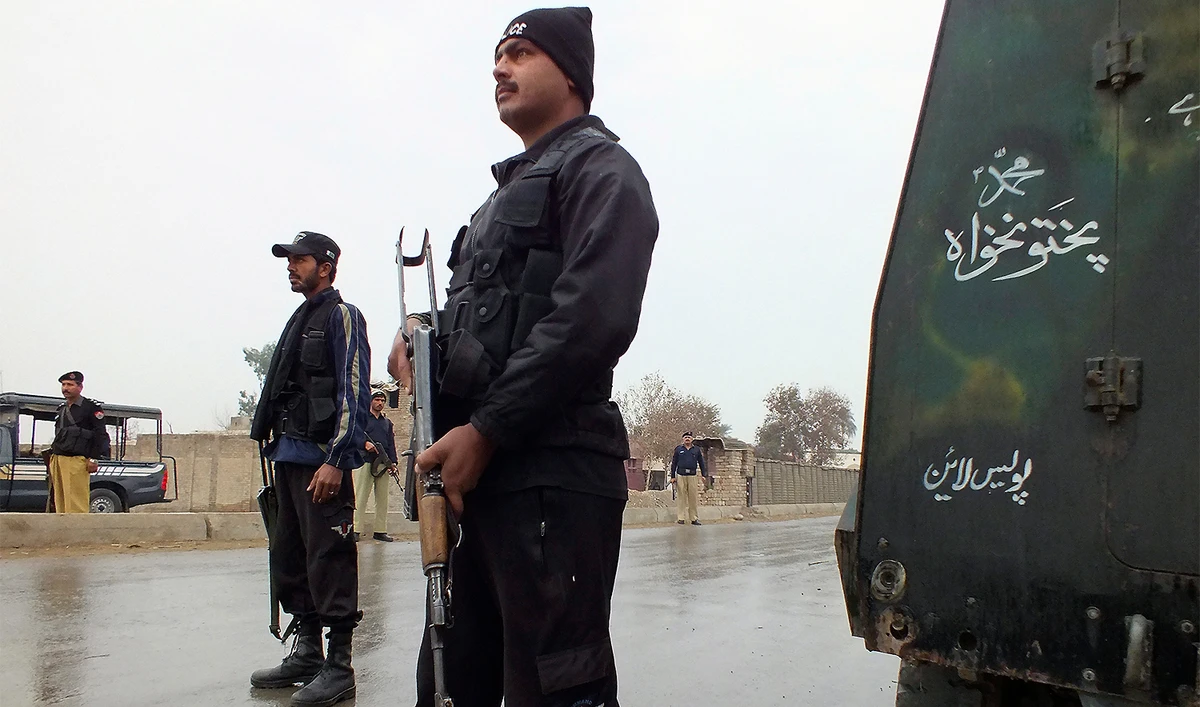 Policemen stand guard as they cordon the road leading to an isolated army checkpoint after it was attacked by militants at Lakki Marwat in the outskirts of Dera Ismail Khan on February 2, 2013. (REUTERS/File)