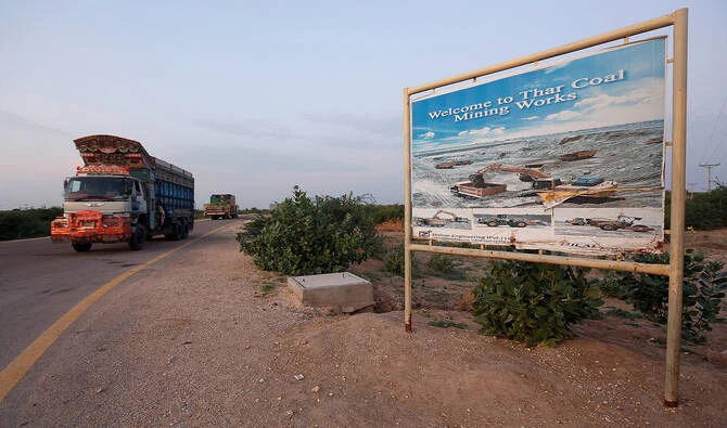 A truck drives past a sign depicting a coal-mining site in Islamkot, Tharparkar, Pakistan, on September 20, 2017. (Reuters/File)
