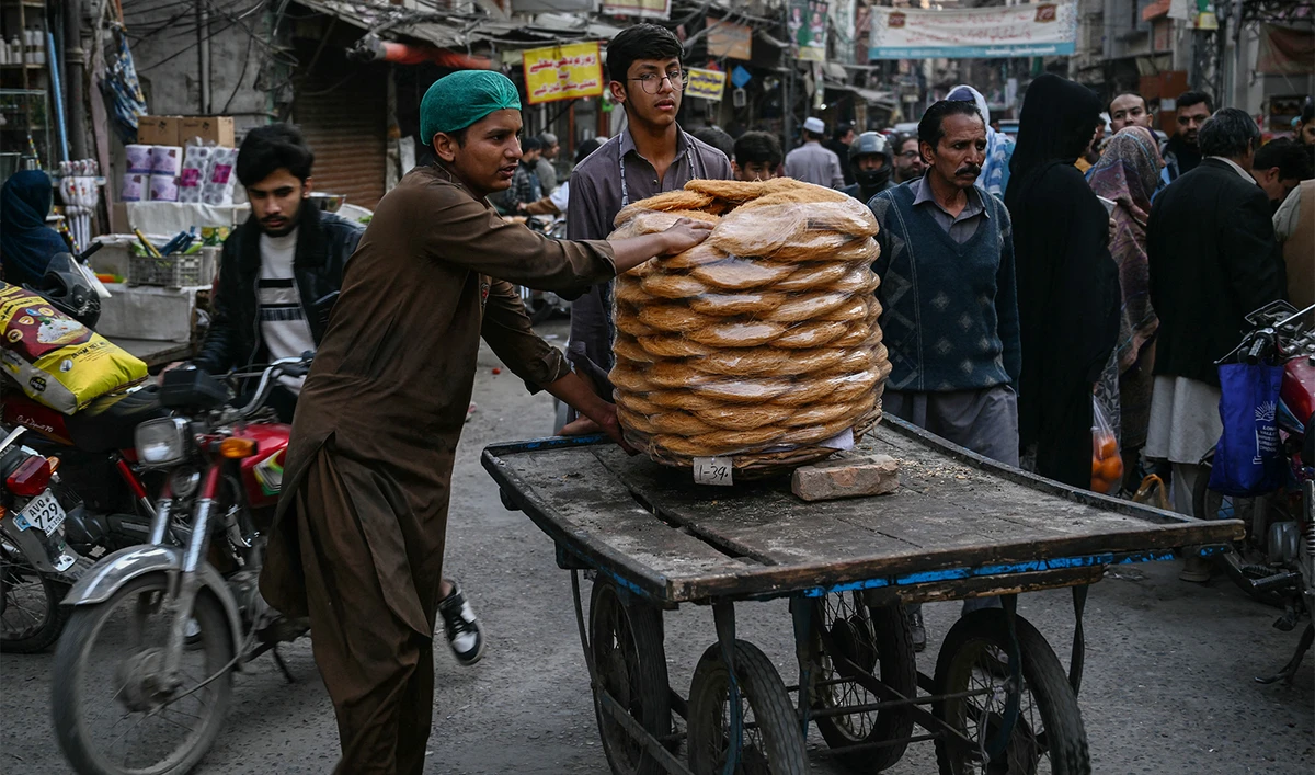 People transport vermicelli loaded on a cart on the first day of the Islamic holy fasting month of Ramadan in Rawalpindi on February 19, 2026. (AFP)