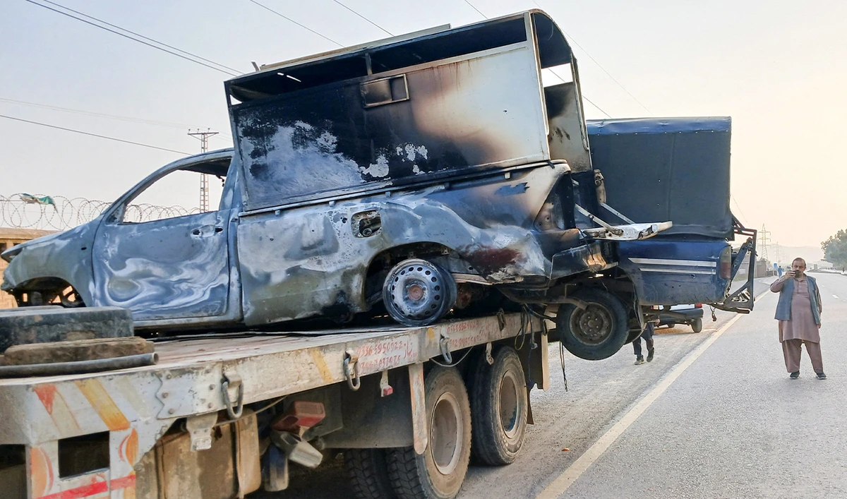 A man uses his mobile to film the damaged police vehicles, loaded on a truck, after a terrorist attack in Kohat, in Khyber Pakhtunkhwa province, Pakistan, on February 24, 2026. (REUTERS/File)