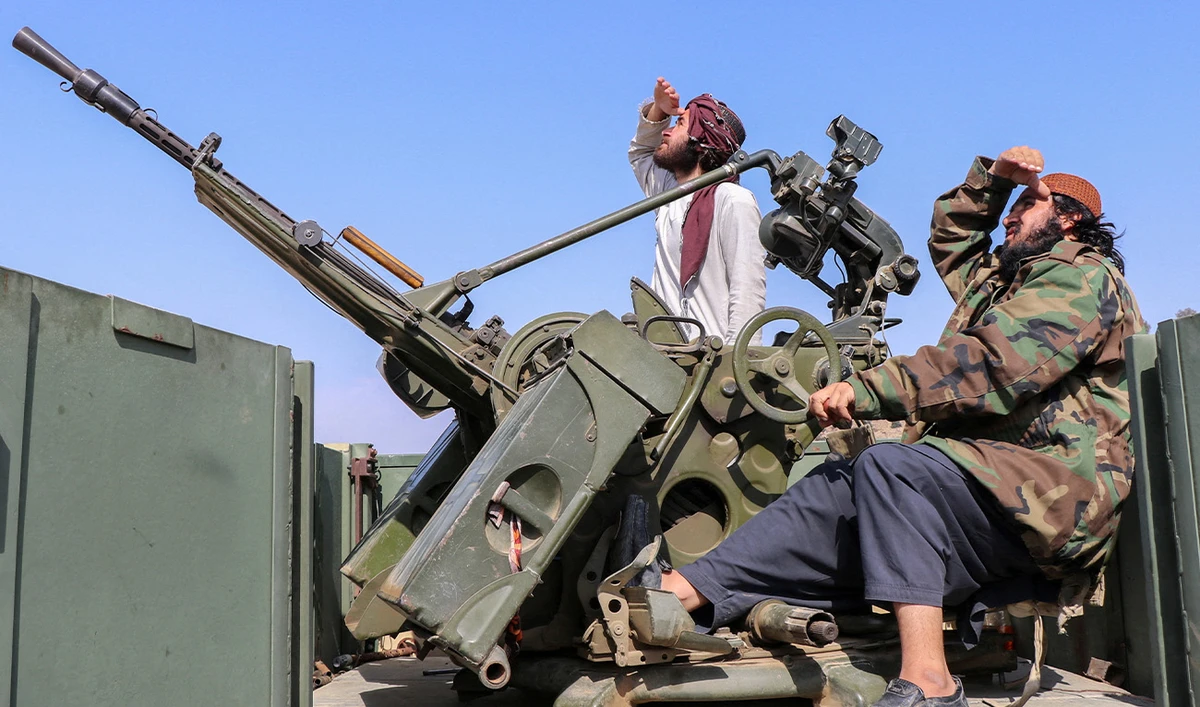 Taliban soldiers sit next to an anti-aircraft gun while on lookout for Pakistan's fighter jets, in Khost province, Afghanistan, February 27, 2026. (Reuters)