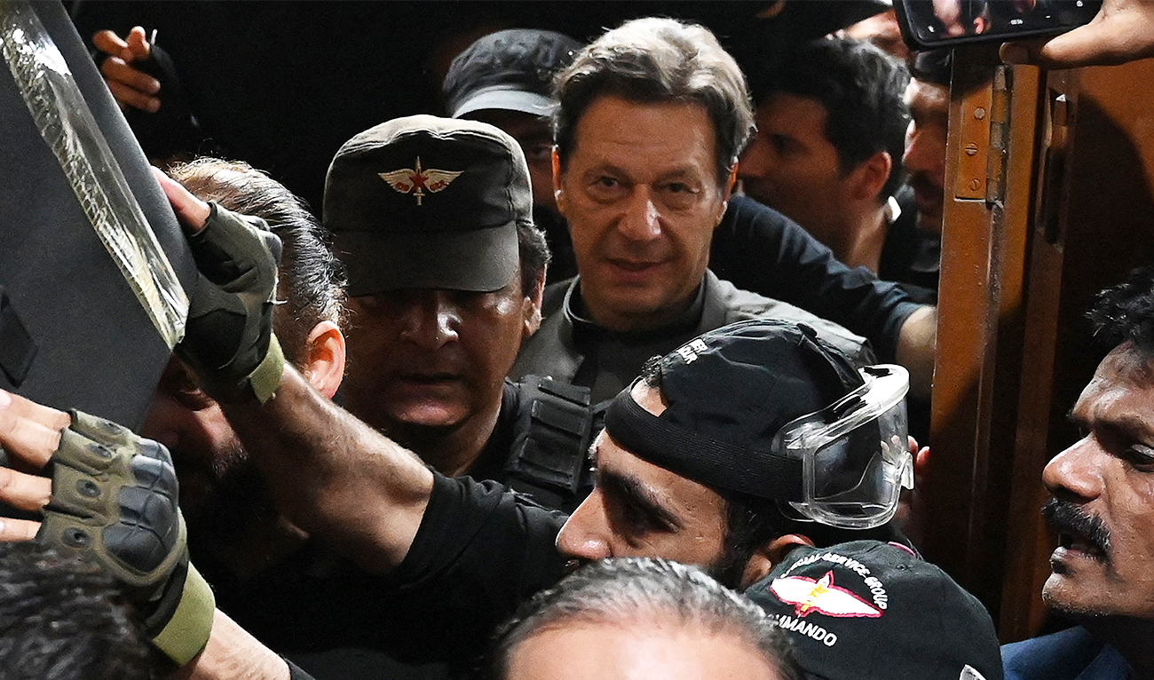 Pakistan’s former prime minister Imran Khan (C) leaves after appearing before a court for a protective bail in relation to two cases, in Lahore on March 21, 2023. (AFP/File)