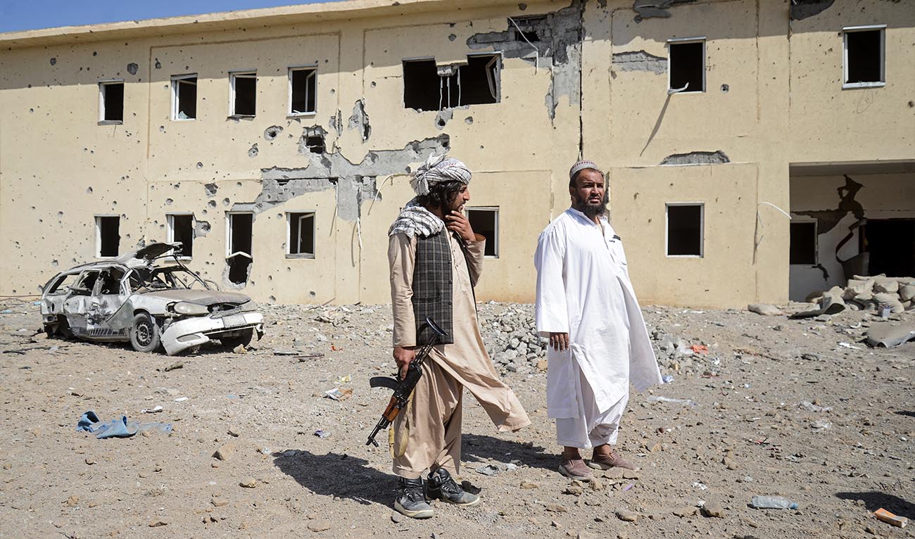 Taliban security personnel stand at the site of a Pakistani air strike near a refugee registration center in the Takhta Pul district of Kandahar on February 28, 2026. (AFP)