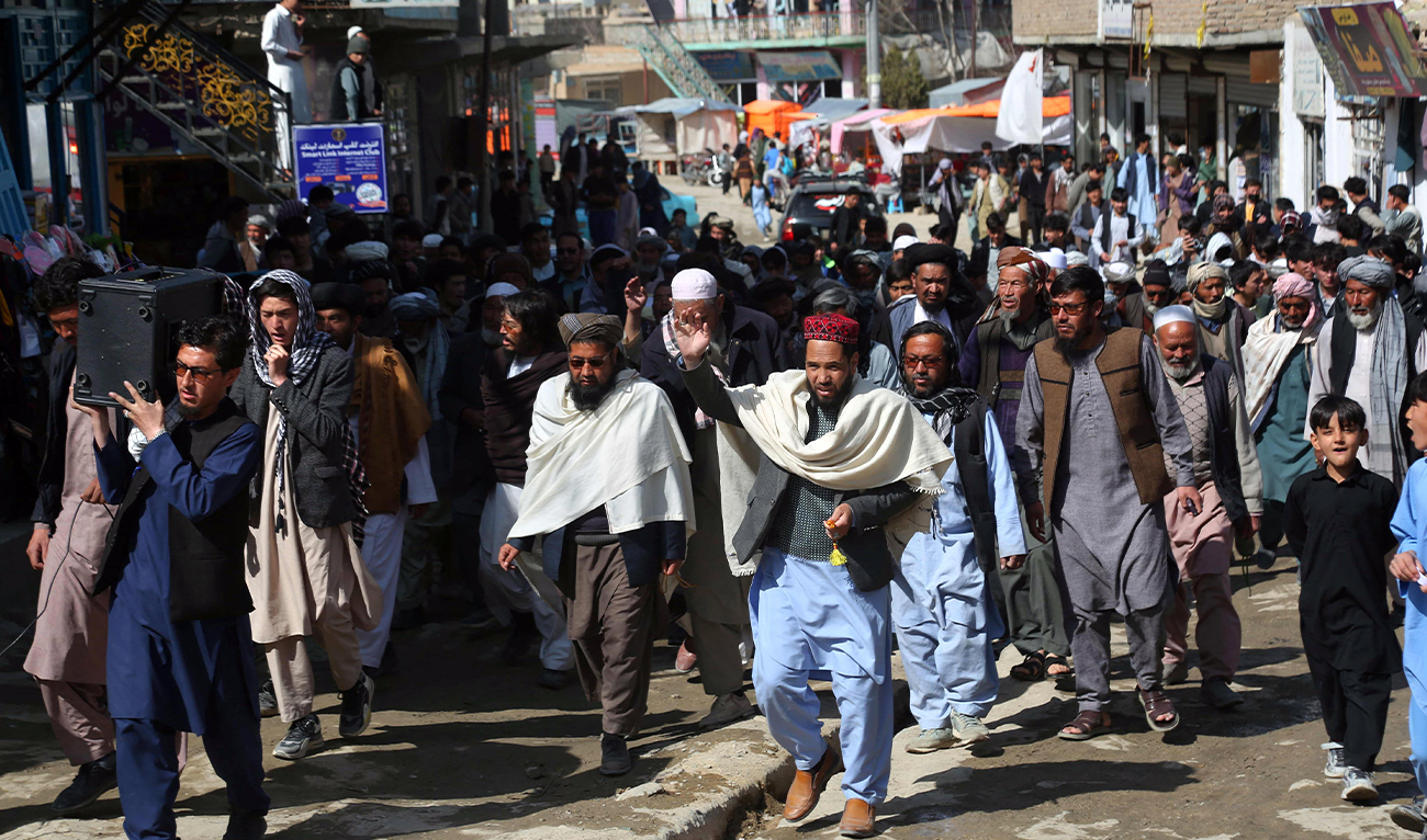 Afghans march through a market to show their solidarity for the Taliban, in Ghazni, Afghanistan, on March 3, 2026. (AFP)