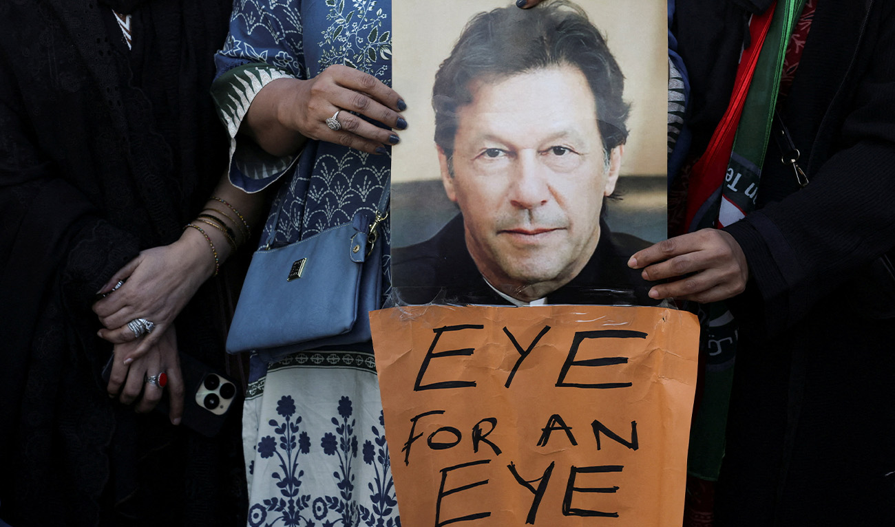 Supporters of jailed former Prime Minister Imran Khan's Pakistan Tehreek-e-Insaf (PTI) party carry a poster of him during a protest over concerns about their leader's health in Karachi, Pakistan, February 13, 2026. (Reuters/File)