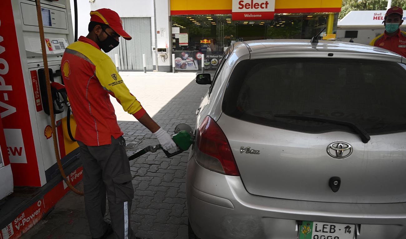 A petrol station worker wearing a facemask fills a vehicle's tank during a government-imposed nationwide lockdown as a preventive measure against the COVID-19 coronavirus, in Islamabad on April 22, 2020. (AFP/ file)
