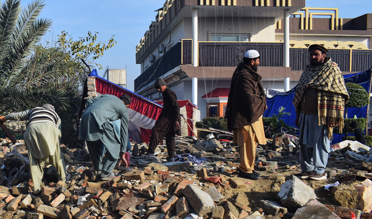 Local residents clear the rubble at the site of a suicide bombing, on the outskirts of Dera Ismail Khan district in Khyber Pakhtunkhwa province of Pakistan, on January 24, 2026. (AP/File)