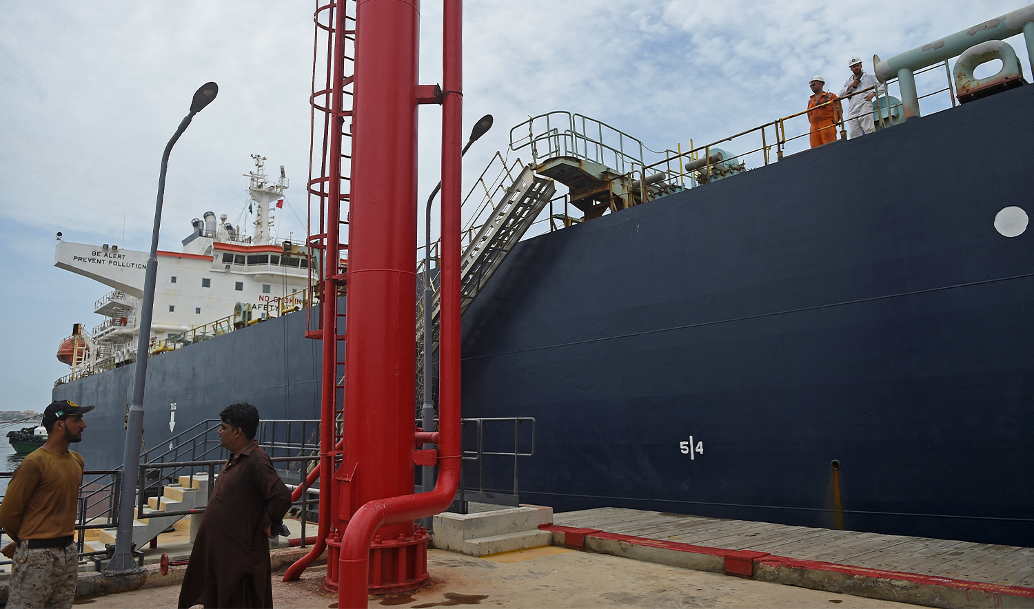 A security personnel stands next to a Russian cargo ship carrying crude oil at the Karachi port in Karachi on June 28, 2023. (AFP/File)