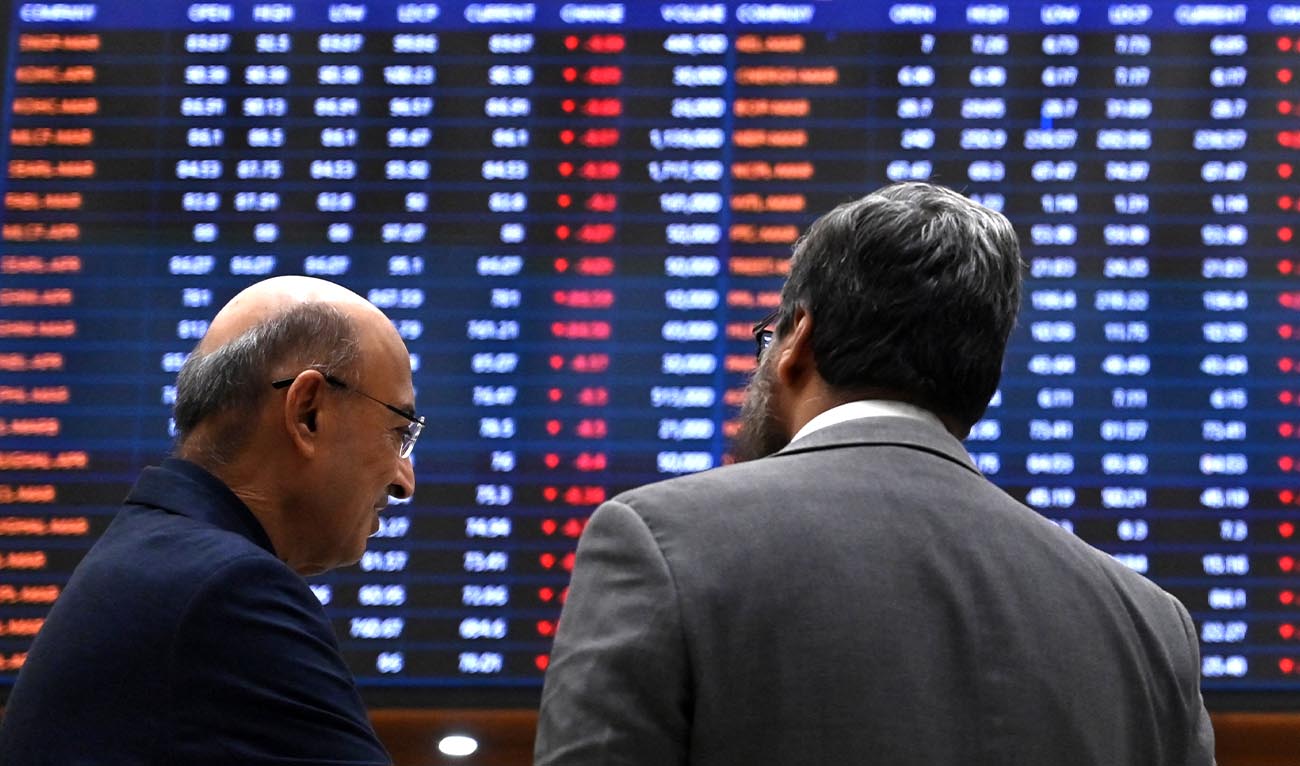 Stockbrokers react while monitoring share prices at the Pakistan Stock Exchange (PSX) in Karachi on March 2, 2026. (AFP)