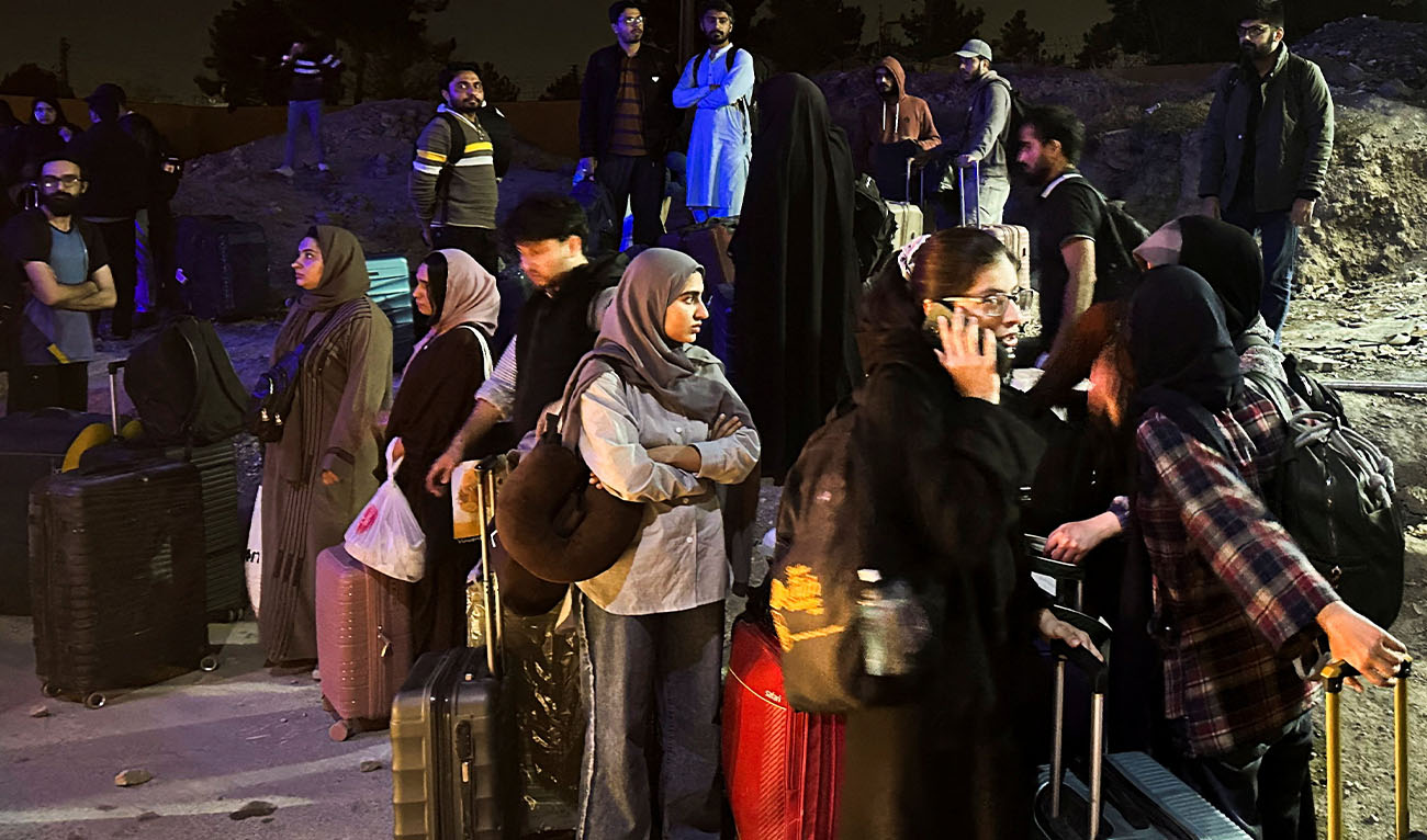 Pakistani families and students stand with their belongings after returning from Iran following the U.S. and Israeli strikes, in Quetta, Pakistan, March 3, 2026. (Reuters/File)