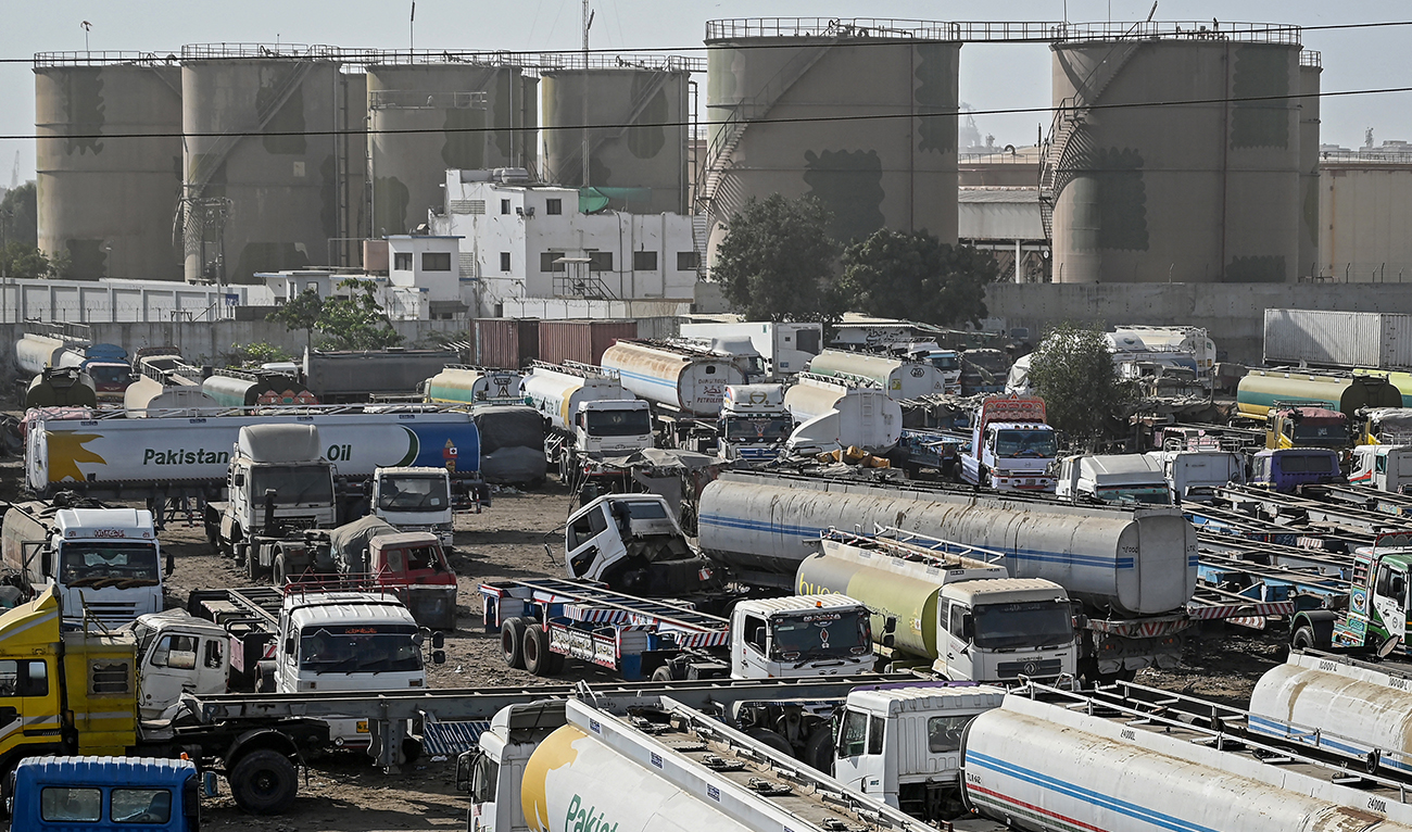 Oil tanker trucks stand parked near an oil storage terminal in Karachi, Pakistan, on March 12, 2026. (AFP)