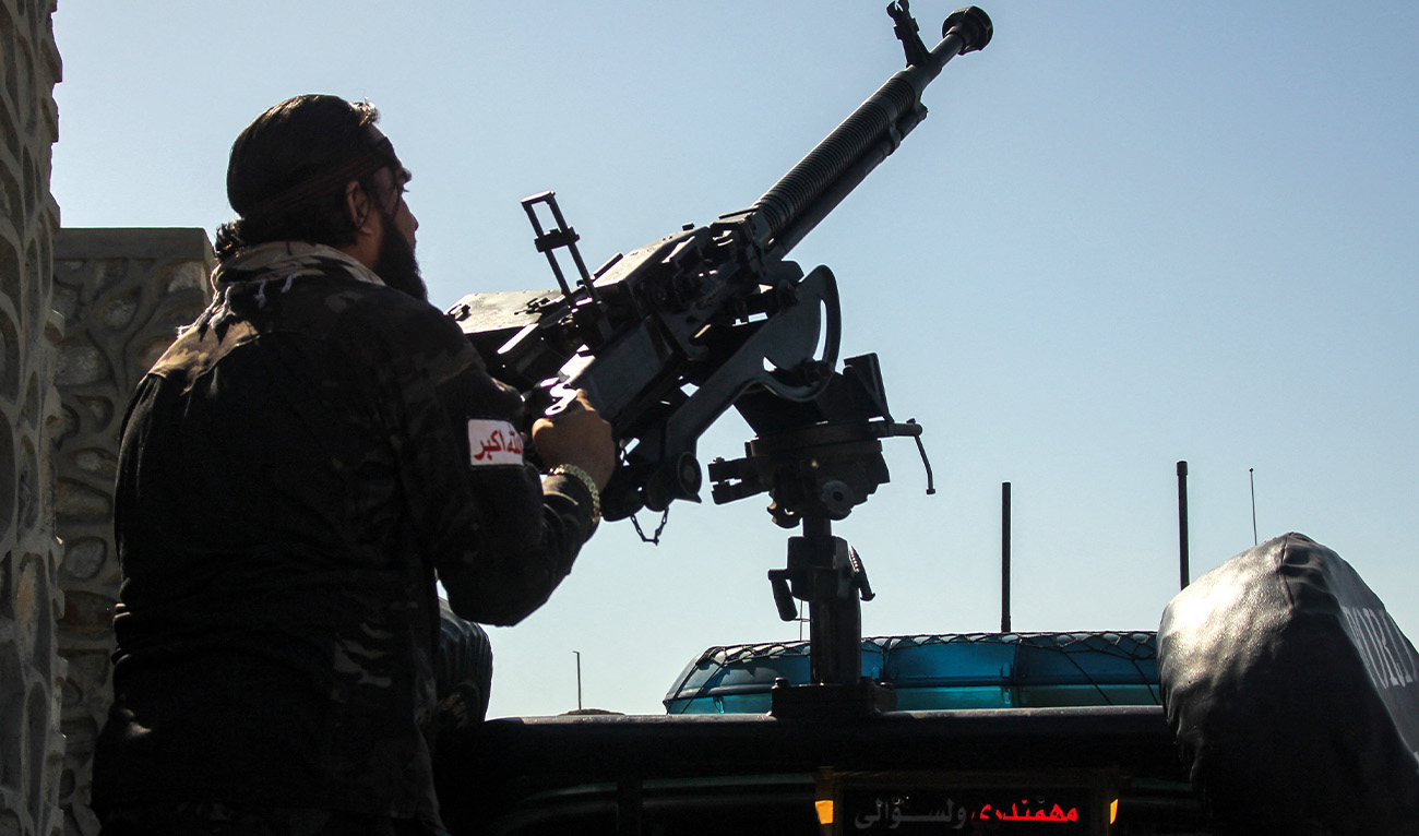 A Taliban security personnel manning a gun sits in the back of a vehicle amid the ongoing clashes between Afghanistan and Pakistani forces in the Momand Dara district of Nangarhar province on March 13, 2026. (AFP)