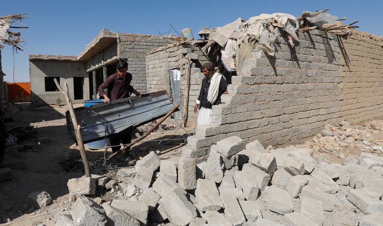 Residents inspect the damage after what locals say was a possible drone that hit a residential house in the Sarah Gharghai area, in Quetta, Pakistan, March 14, 2026. (Reuters)