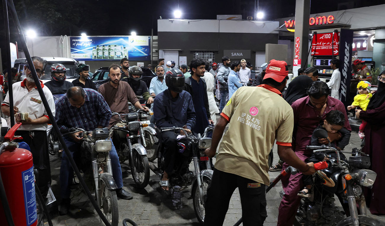People wait for their turn to get fuel at a petrol station, amid the U.S. and Israeli conflict in Iran, in Karachi, Pakistan March 6, 2026. (Reuters/File)
