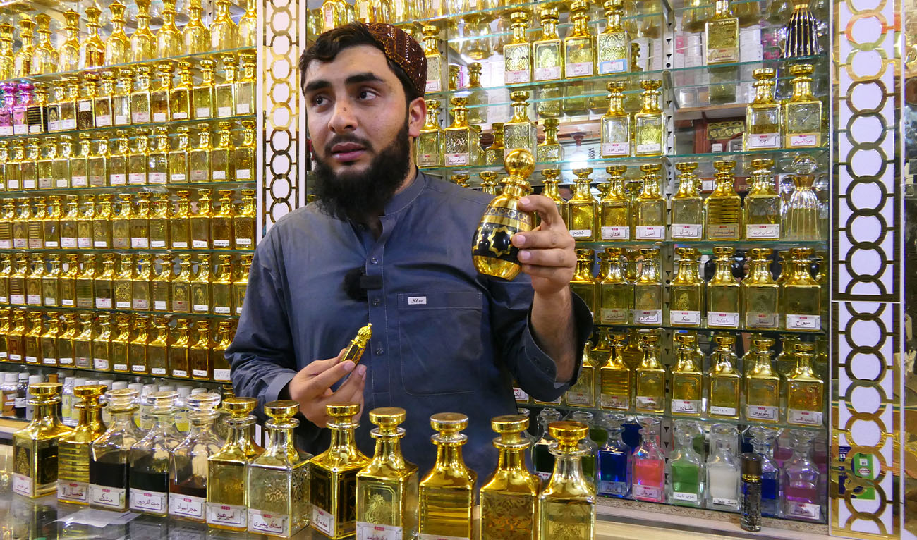 A shopkeeper holds a bottle of perfume at his shop in Quetta, where demand for affordable fragrance replicas rises ahead of Eid Al-Fitr, on Macrh 15, 2026. (AN photo)