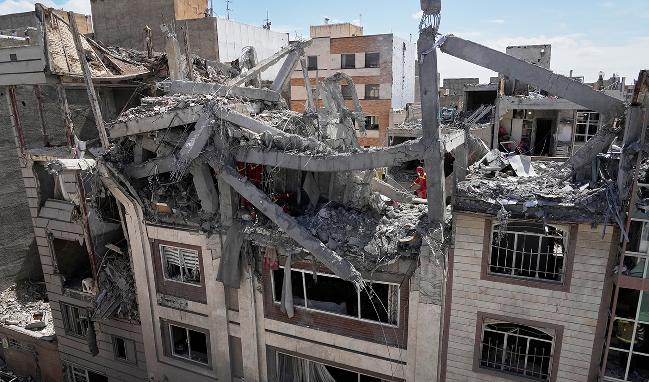 First responders inspect a residential building hit in an earlier US-Israeli strike in Tehran, Iran, on March 27, 2026. (AP)