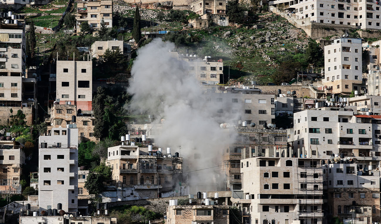 Smoke rises as Israeli authorities demolish the house of Mahmoud al-Aqqad, a Palestinian man who was killed last year near Qalqilyah after reportedly killing an Israeli soldier, in the occupied West Bank city of Nablus on March 28, 2026. (AFP/File)