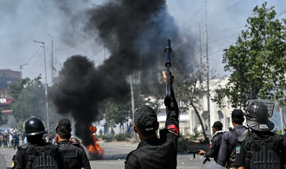 Security personnel fire tear gas as Shiite Muslims shout slogans during a protest outside the US consulate in Karachi on March 1, 2026 after the death of Iran's supreme leader Ayatollah Ali Khamenei amid US-Israel strikes. (AFP)