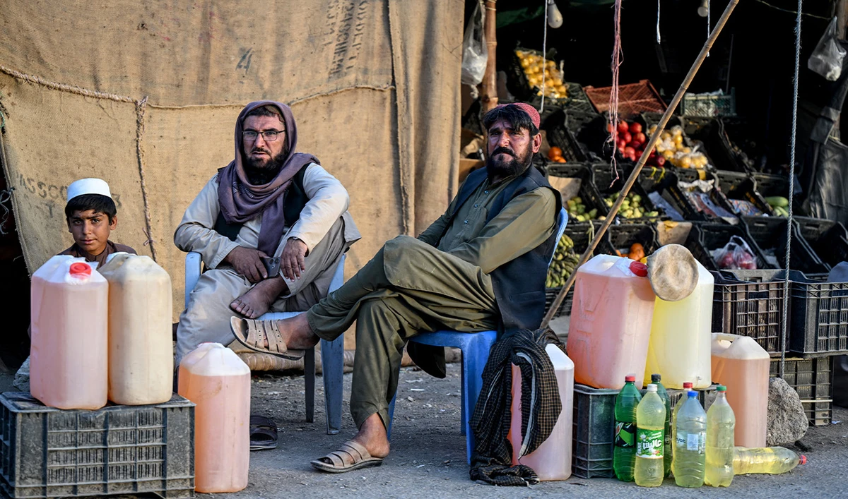 Pakistani men selling petrol wait for customers at their stall in the Pakistan–Iran border town of Taftan, Balochistan province on March 4, 2026. (AFP/File)