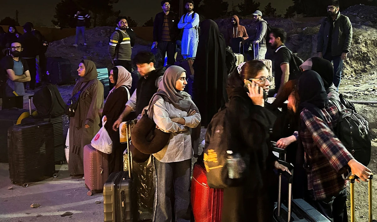 Pakistani families and students stand with their belongings after returning from Iran following the U.S. and Israeli strikes, in Quetta, Pakistan, March 3, 2026. (Reuters/File)