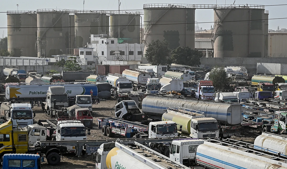 Oil tanker trucks stand parked near an oil storage terminal in Karachi, Pakistan, on March 12, 2026. (AFP)
