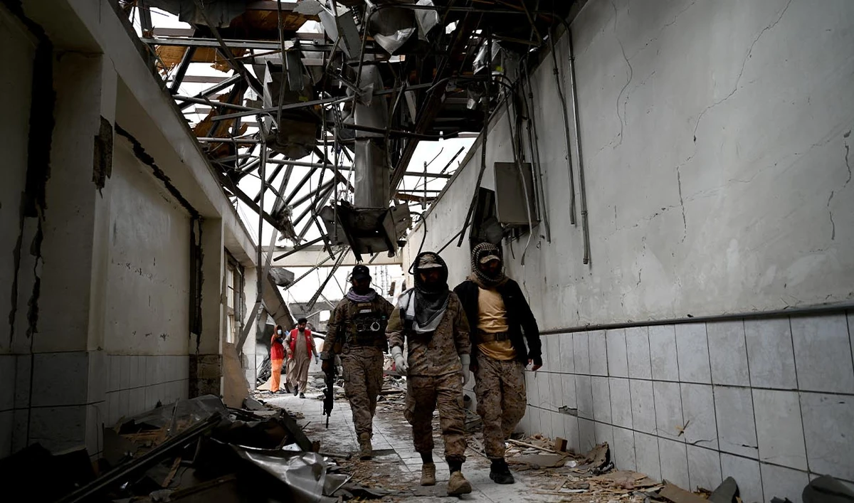 Taliban security personnel walk at the site, after Pakistani airstrikes hit the Omid Addiction Treatment Hospital in Kabul, on March 17, 2026. (AFP)