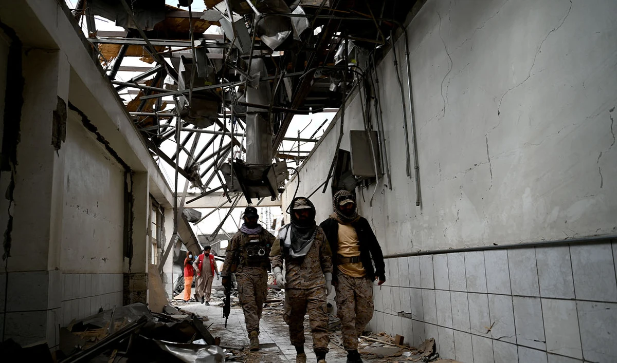 Taliban security personnel walk at the site, after Pakistani airstrikes hit the Omid Addiction Treatment Hospital in Kabul, on March 17, 2026. (AFP/File)