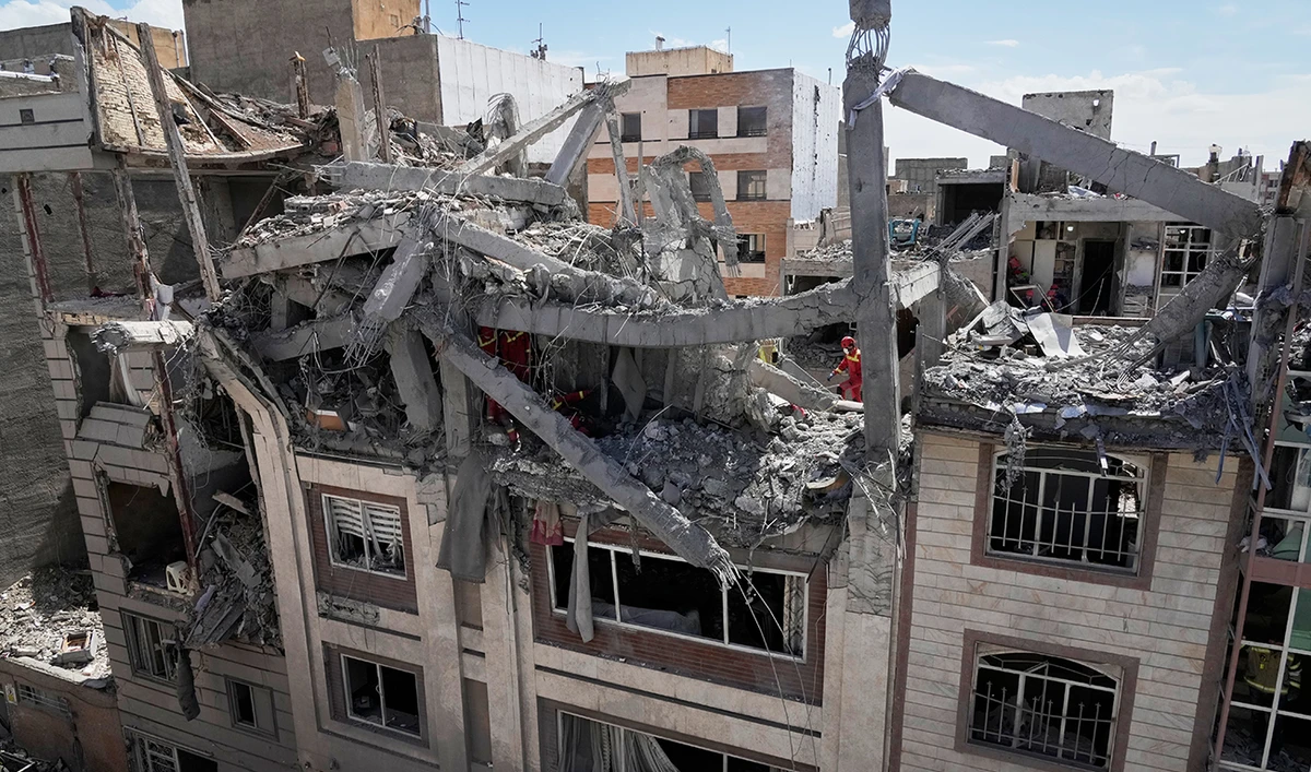 First responders inspect a residential building hit in an earlier US-Israeli strike in Tehran, Iran, on March 27, 2026. (AP)