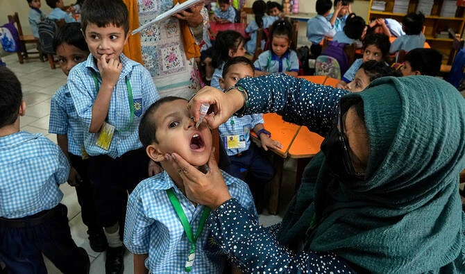 A health worker administers a polio vaccine to a child in a school in Karachi, Pakistan, on September 1, 2025. (AP/File)