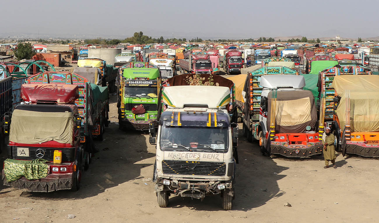 Stranded trucks with goods parked near the closed Ghulam Khan zero-point border crossing between Afghanistan and Pakistan in Gurbuz district in the southeast of Khost province on October 20, 2025. (AFP/ FILE)